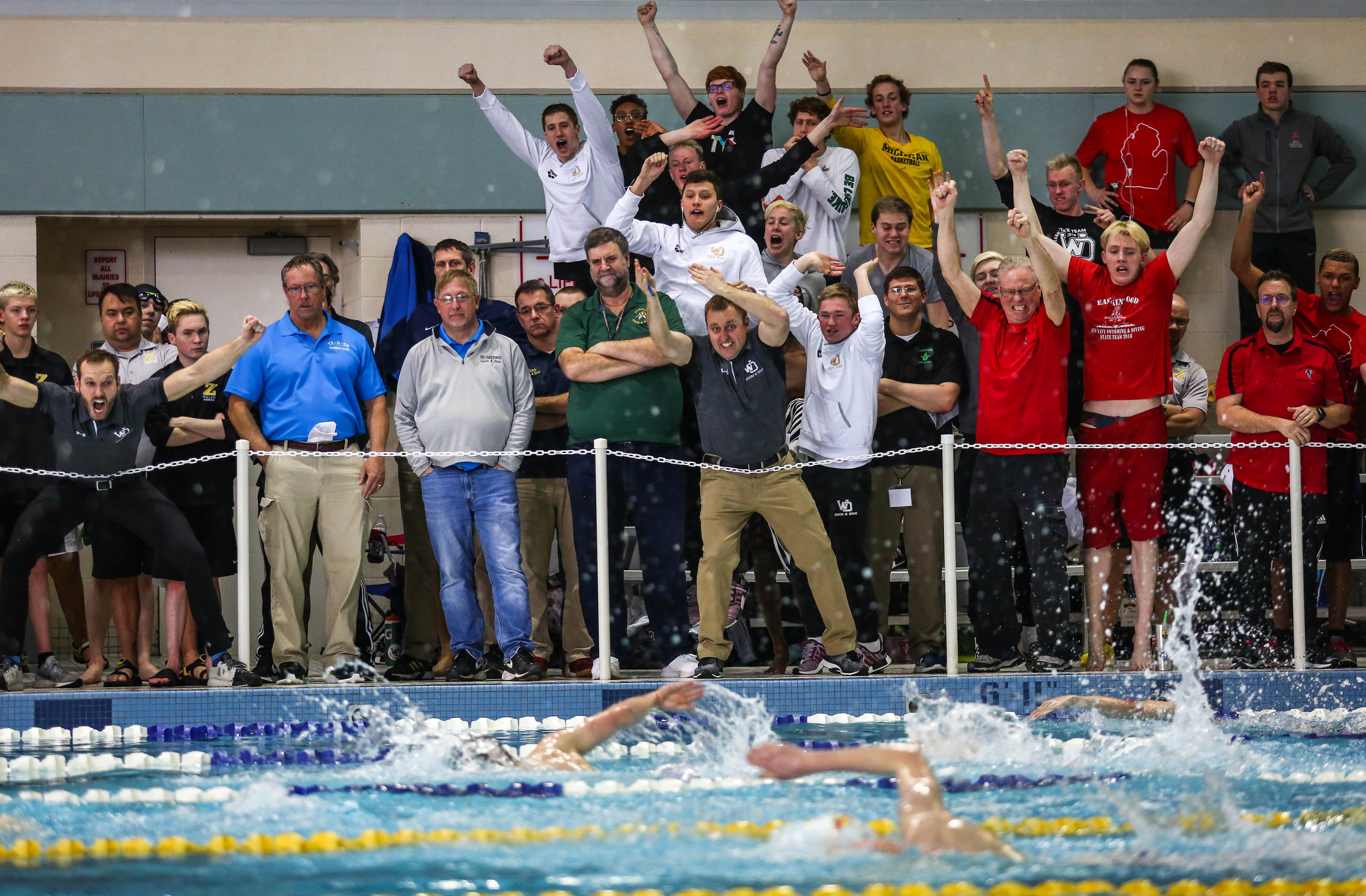  Multiple teams cheer on their swimmers in the boys 500-yard freestyle competition during Saturday’s Division 1 boys swimming state finals at the Holland Aquatic Center in Holland, Michigan on March 9, 2019. 