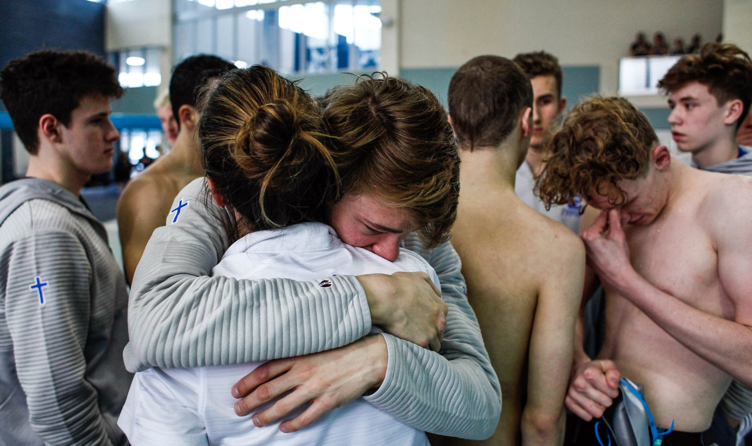  Detroit Catholic Central swimmers console each other after placing runner-up in the Division 1 boys swimming state finals at the Holland Aquatic Center in Holland, Michigan on Saturday, March 9, 2019. 