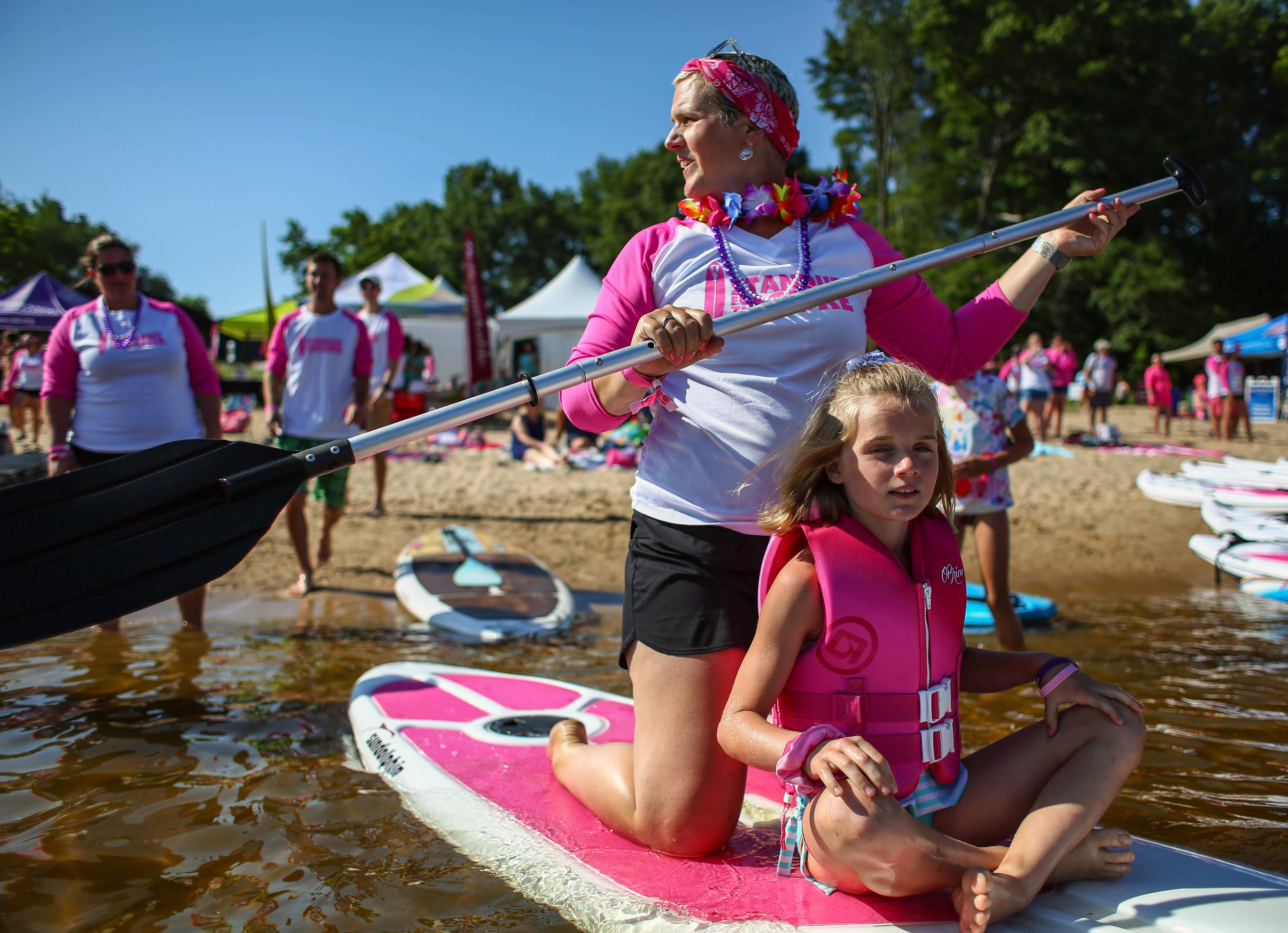  Amanda and her daughter Kayla paddle into Mona Lake along with hundreds of others during Saturday’s Stand Up for the Cure event in Norton Shores, Michigan on July 13, 2019. 