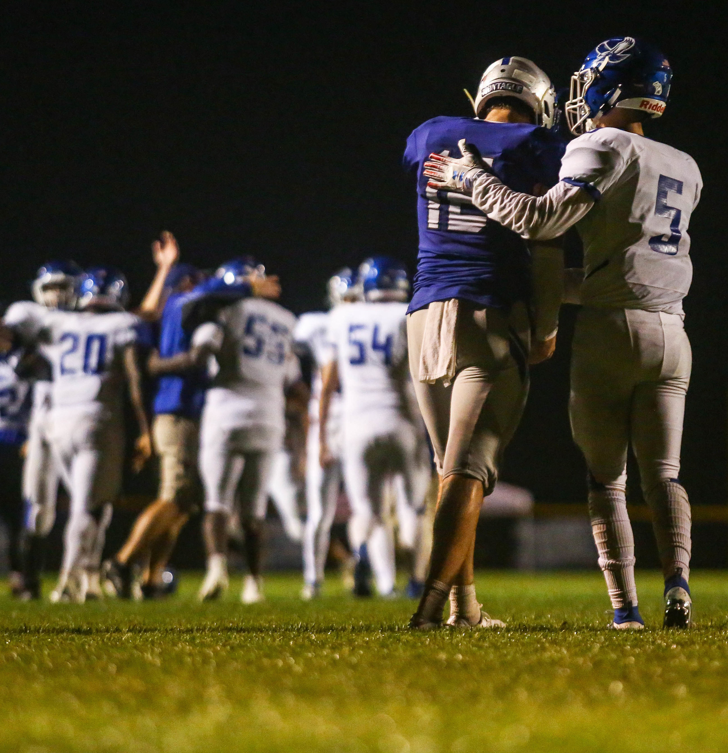  In a display of good sportsmanship, Oakridge's Ethan Carmean (5) consoles Montague quarterback Drew Collins (12) after the Eagles' dramatic 15-13 overtime victory over the Wildcats in Montague on Friday, Sept. 27, 2019. 