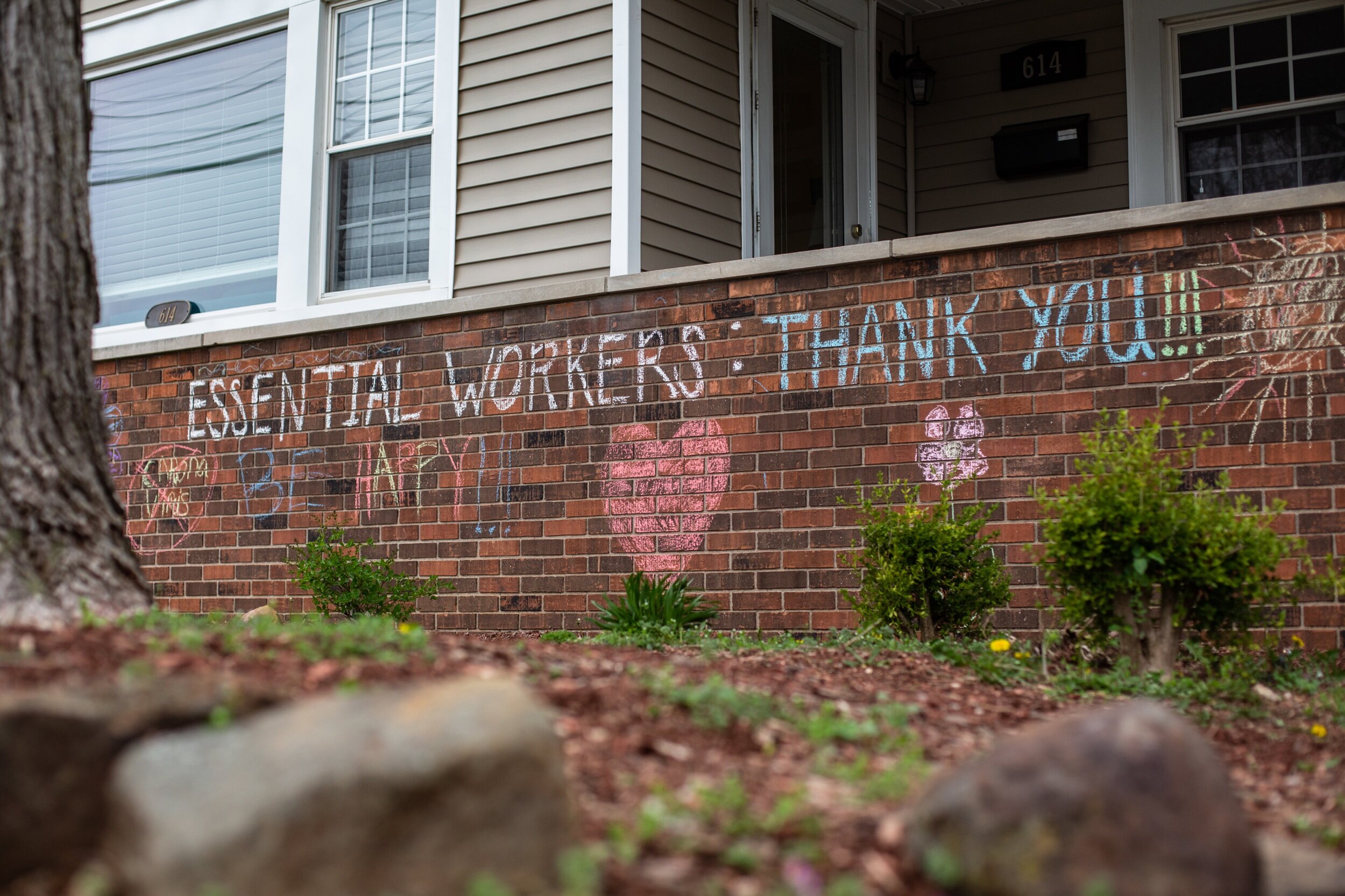 Jeanie Scherer of Jasper and her daughter, Hallie, 9, used chalk to draw messages of encouragement on the front of their house in Jasper on Saturday, March 28, 2020. As people have been self-quarantining and practicing social distancing due to the C