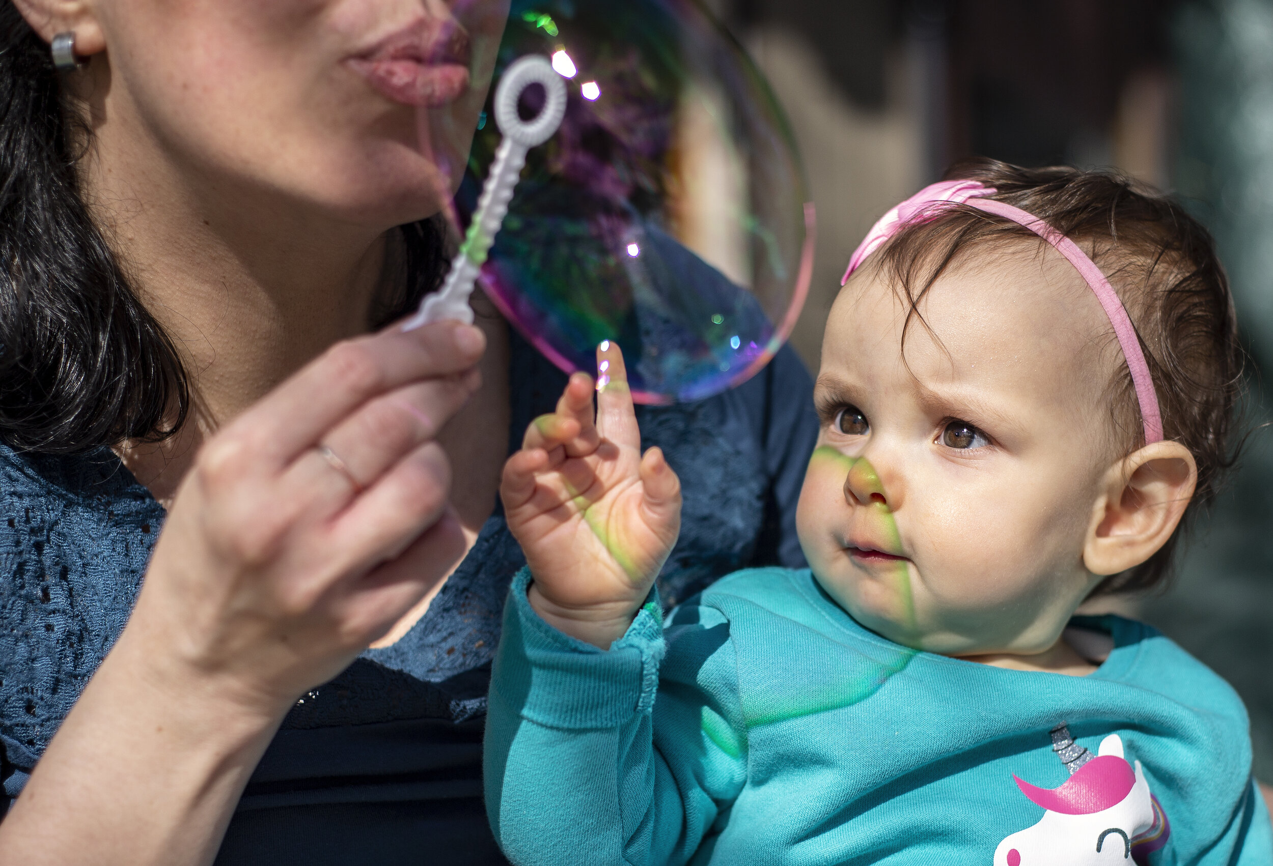  Isadora plays with bubbles for the first time on the family’s back porch on March 18, 2021. It is rare for Isadora to leave the house, so Souza likes to take her outside where she can explore and nurture her curiosity in a way that’s safe. 