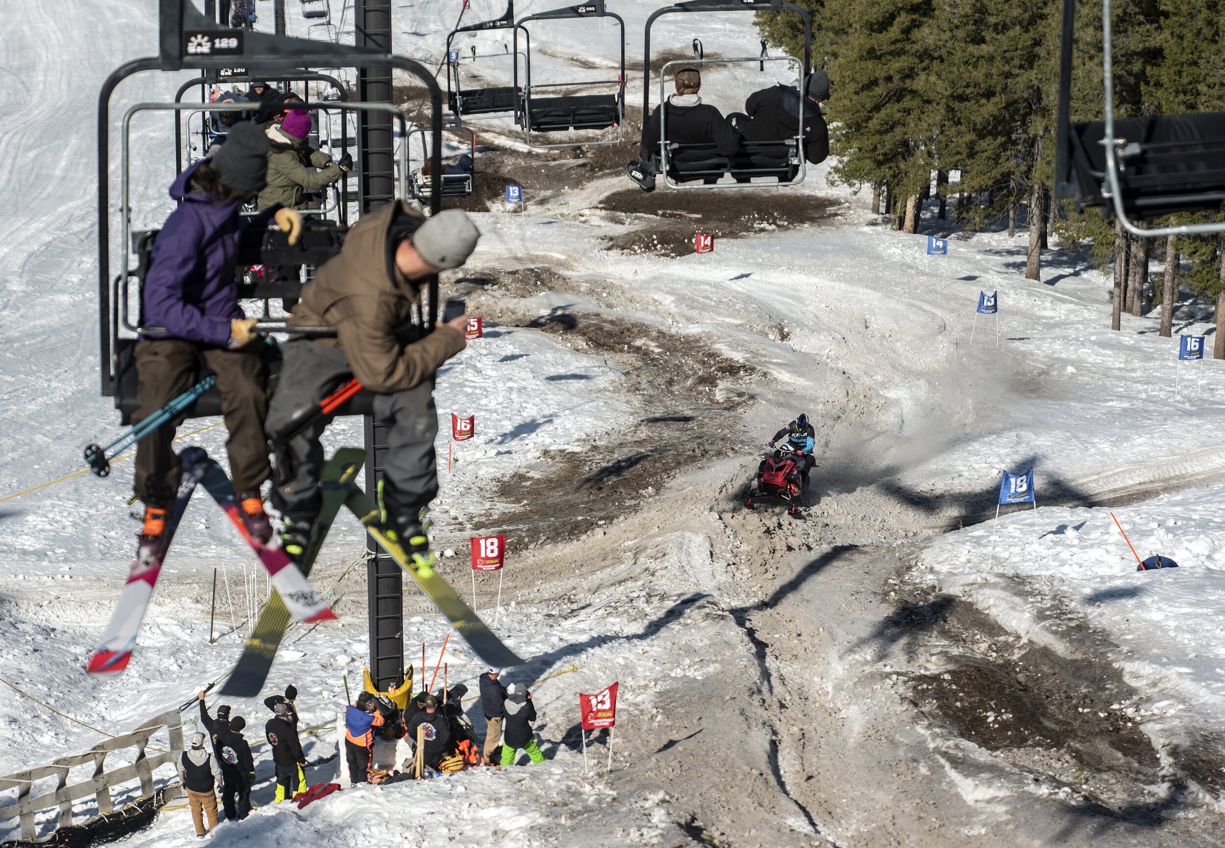  Skiers watch from the Summit Chair Lift as Brad Sharp makes his way through the course during the 900 modified division at the 44th World Championship Snowmobile Hill Climb at Snow King Mountain in Jackson, Wy. on March 31, 2021.  