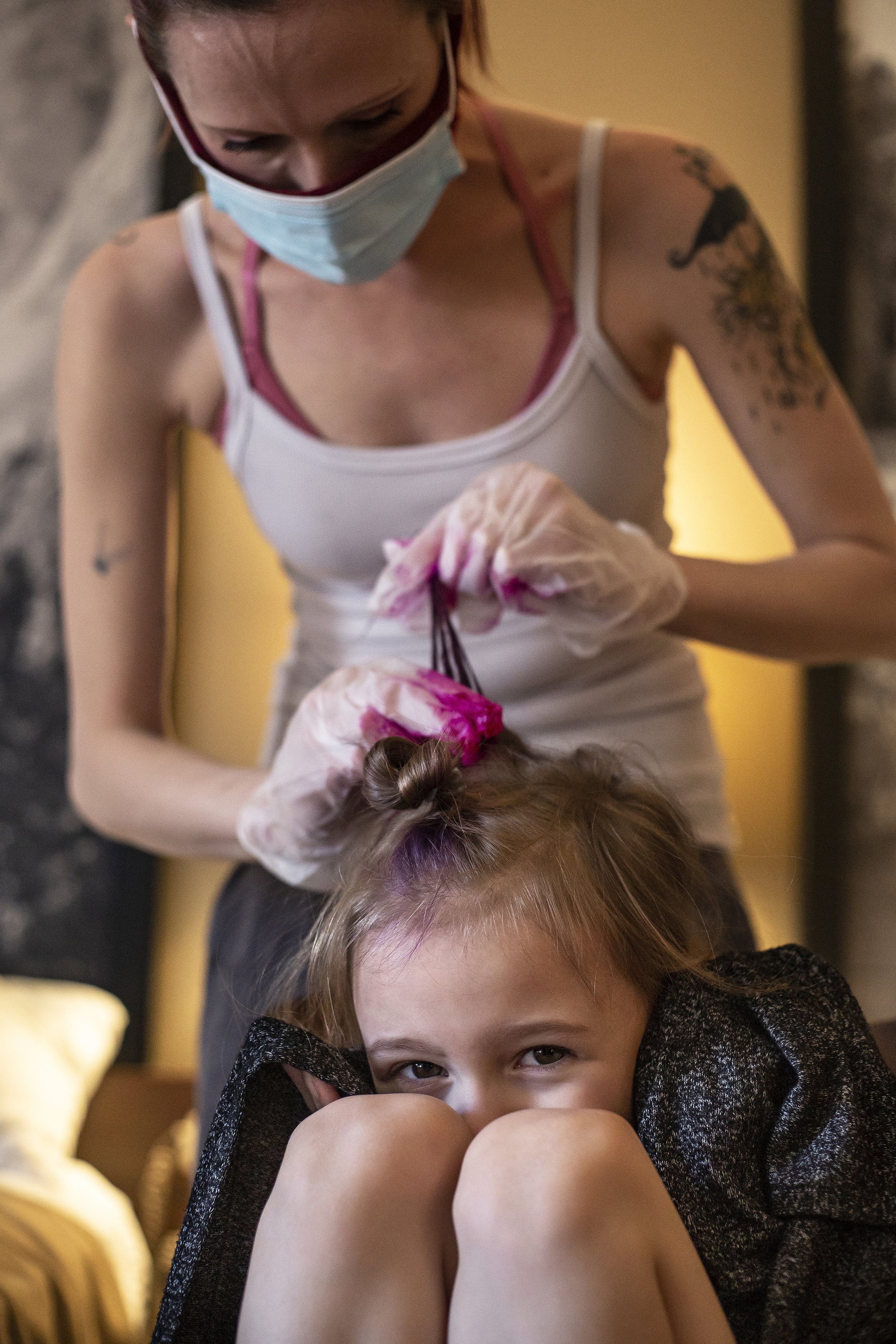  Brandy Lawson dyes the hair of her daughter, Annalia Jo "JoJo," 7, pink inside their room at the Super 8 on March, 27, 2021 in Jackson, Wy. "It's one of the ways we keep on the bright side," Lawson said. "It's just fun to have a little color in your