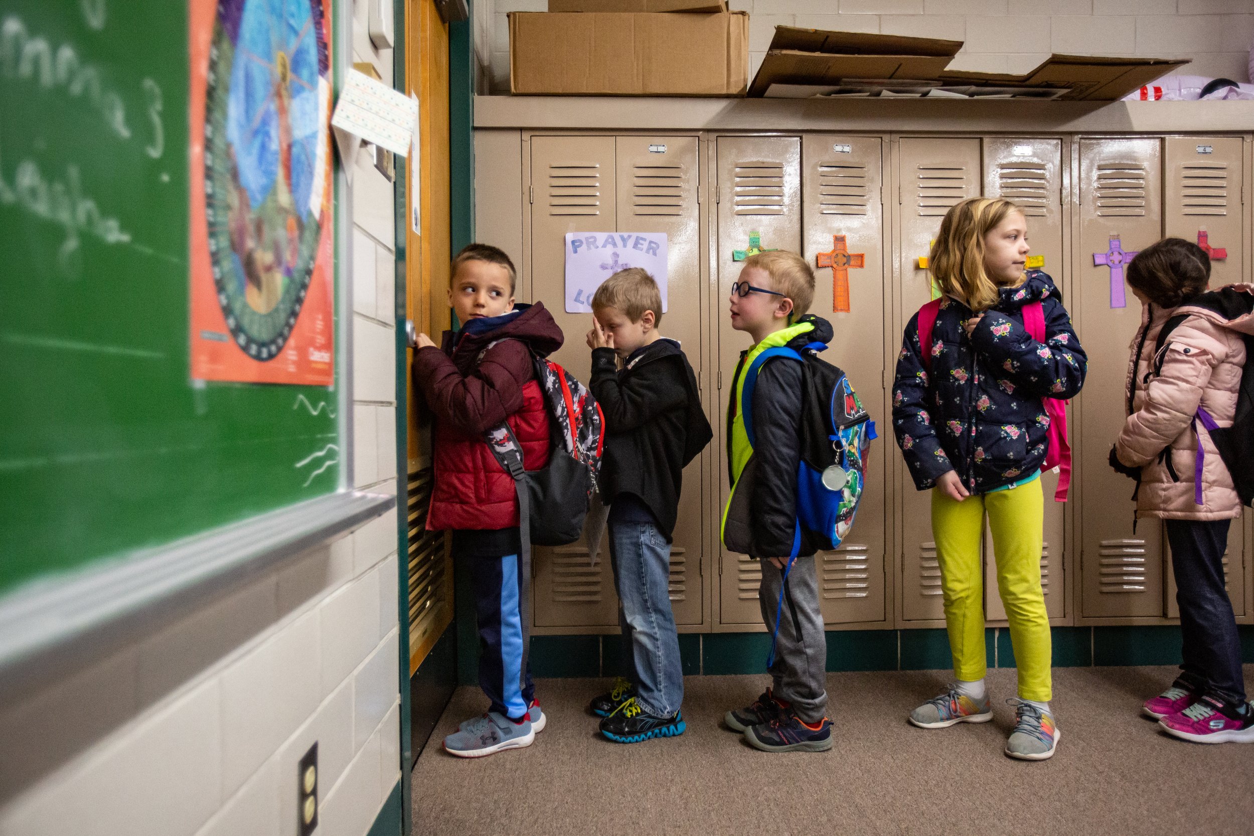  Kindergarteners Weston Rohleder, Henry Verkamp, Liam Cooper, Hallie Nordhoff and Briella Wahl wait in line to leave catechism class at St. Anthony of Padua Church and take the bus to Pine Ridge Elementary to start their school day on Wednesday, Feb.