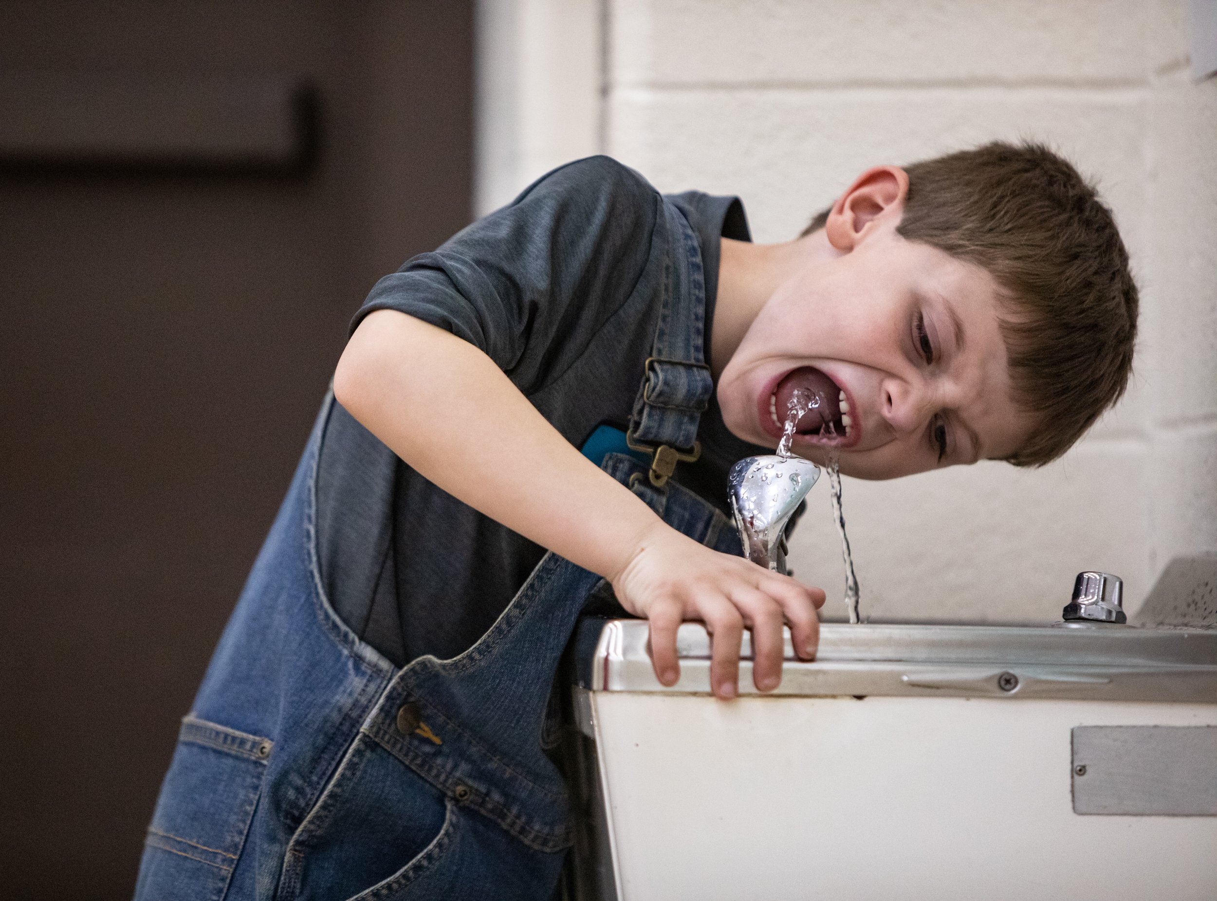  Kindergartener Masyn Waddle drinks from a water fountain during gym class at Pine Ridge Elementary School on Wednesday, Feb. 12 2020. 