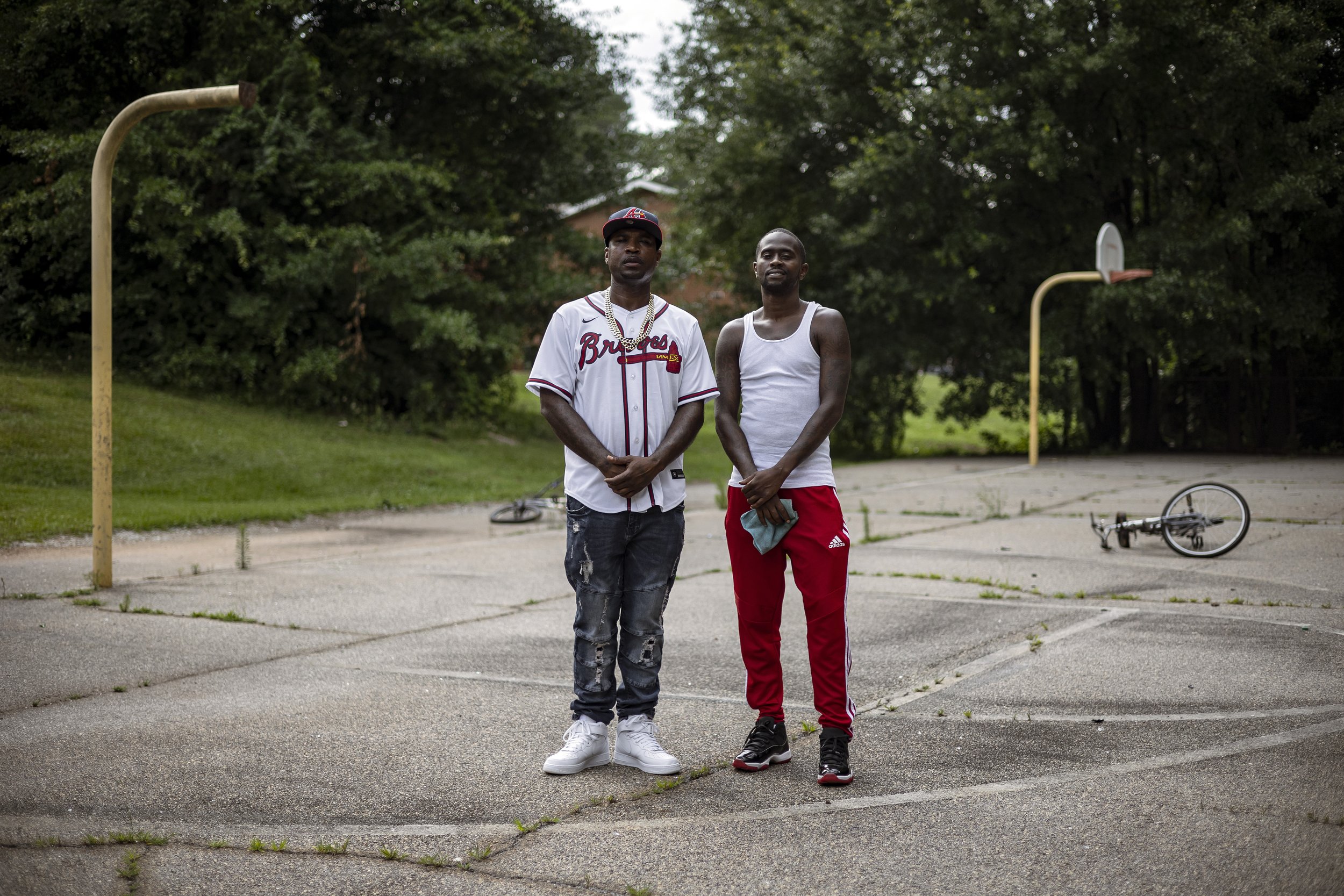  Darius Brightwell, left, and Petier Davis, founders of Save the Youth, stand on the old basketball court that was part of the former Nellie B Library on Thursday, June 10, 2021. The library, which served as a community center, closed several years a