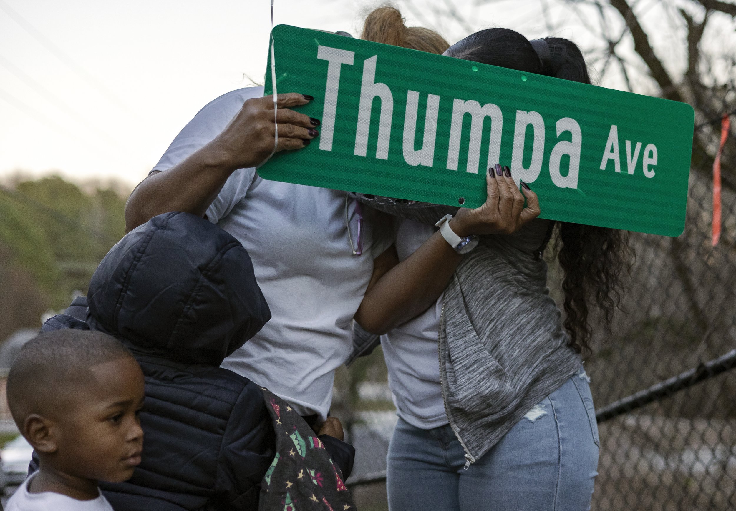  Lashanda Callaway, left, her daughter Keaira “Keke” Rucker and grandsons, Mason Browner, 5, and Braxton Mitchell, 3, become emotional after being gifted a Thumpa Avenue sign of their own during a renaming ceremony on Thursday, Dec. 23, 2021 at Clark