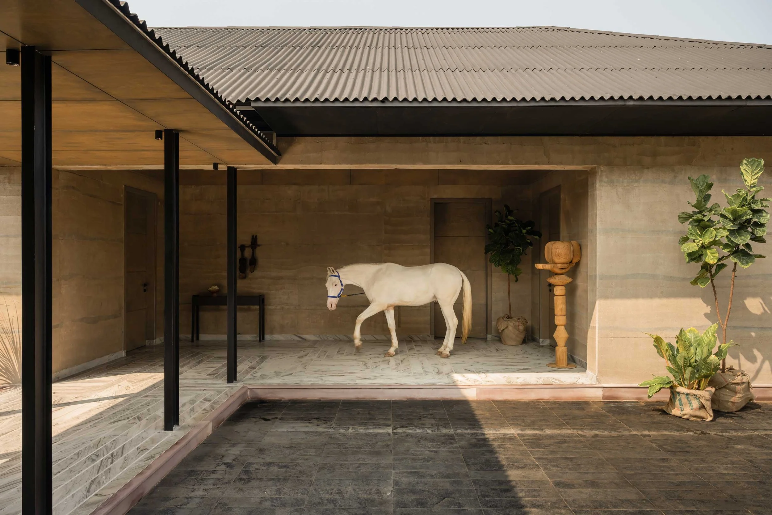 A Rammed Earth Farmhouse Designed for a Family, Three Horses and A Mango Tree