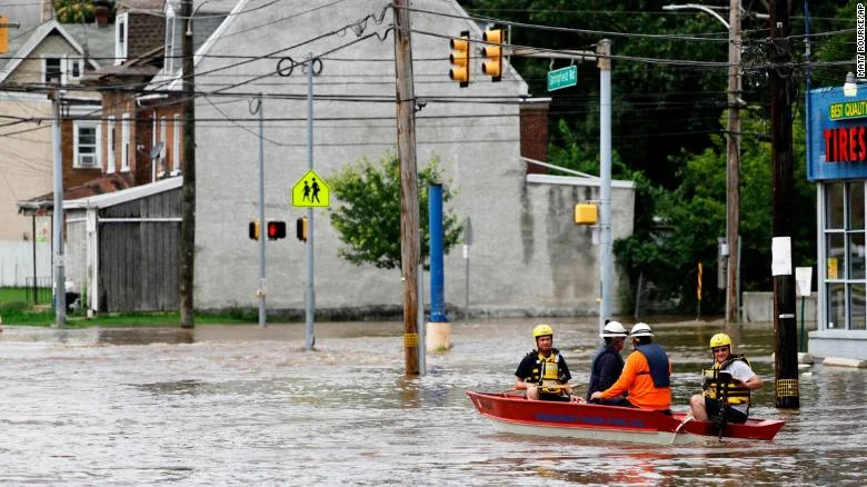 First responders make their way through floodwaters in Darby, Pennsylvania, on Monday.