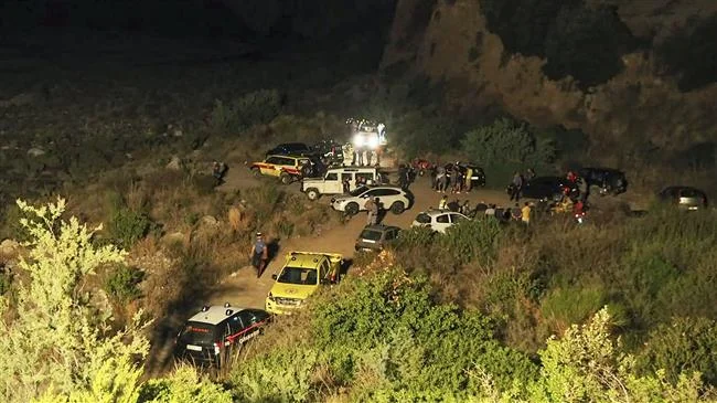 Rescuers are seen at the Raganello Gorge, a popular hiking spot in Civita, a village in the Italian Calabria southern region on August 20, 2018. (AFP)