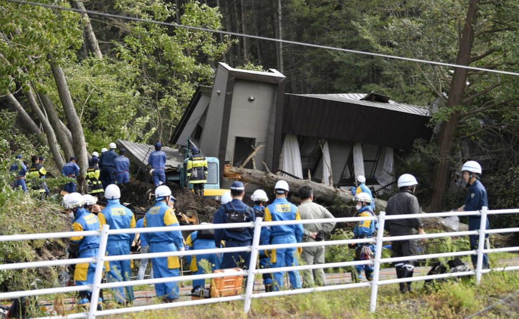 Police officers and rescue workers search for survivors from a building damaged by a landslide caused by a powerful earthquake in Atsuma town in Japan's northern island of Hokkaido, Japan, in this photo taken by Kyodo September 6, 2018. Mandatory credit Kyodo