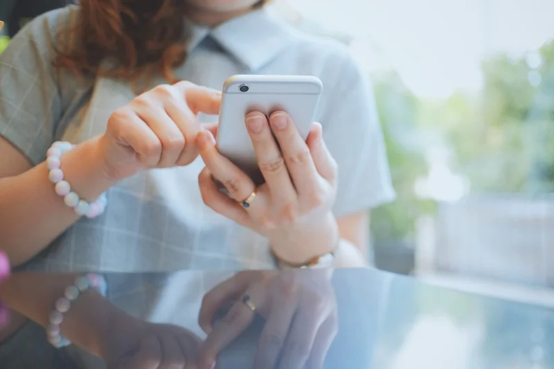 Woman using smartphone or mobile phone in the cafe