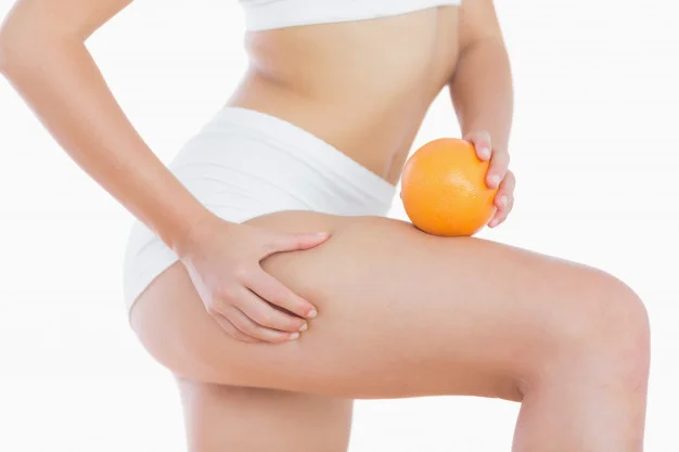 woman-squeezes-cellulite-skin-on-thigh-as-she-holds-orange_13339-956.jpg