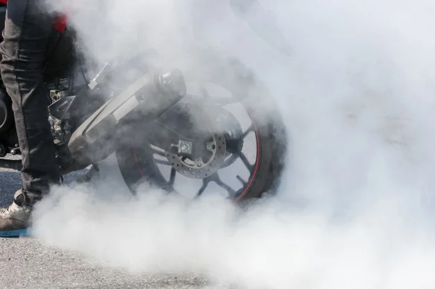 sport-motorbike-wheel-drifting-smoking-track-background-display_38810-1994.jpg