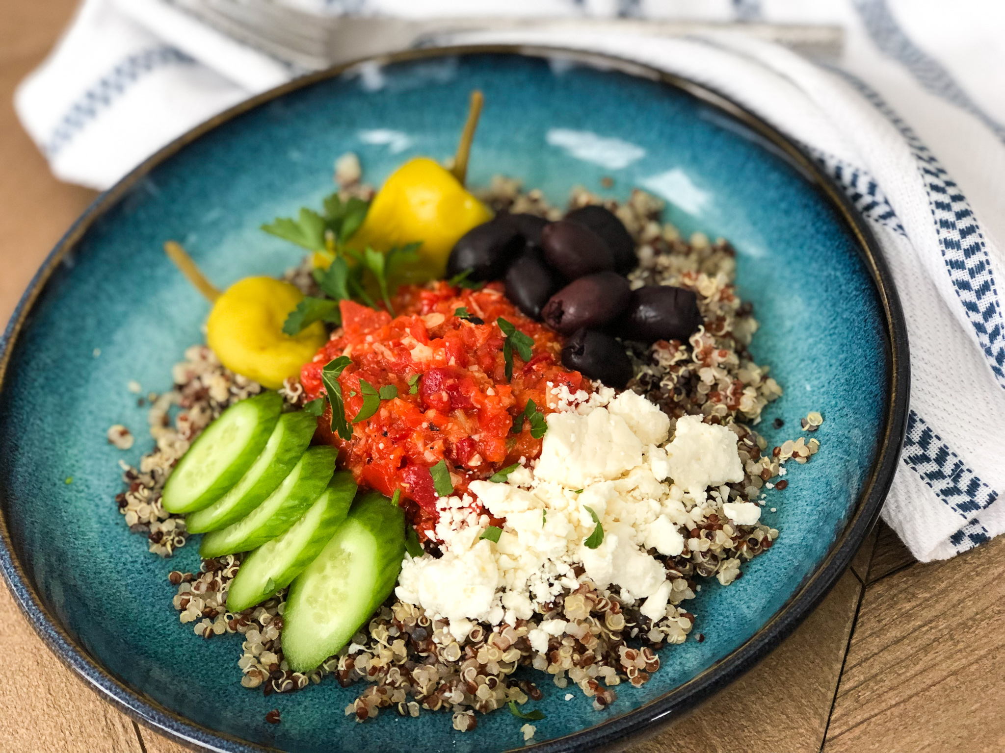 mediterranean quinoa bowl with roasted red pepper sauce
