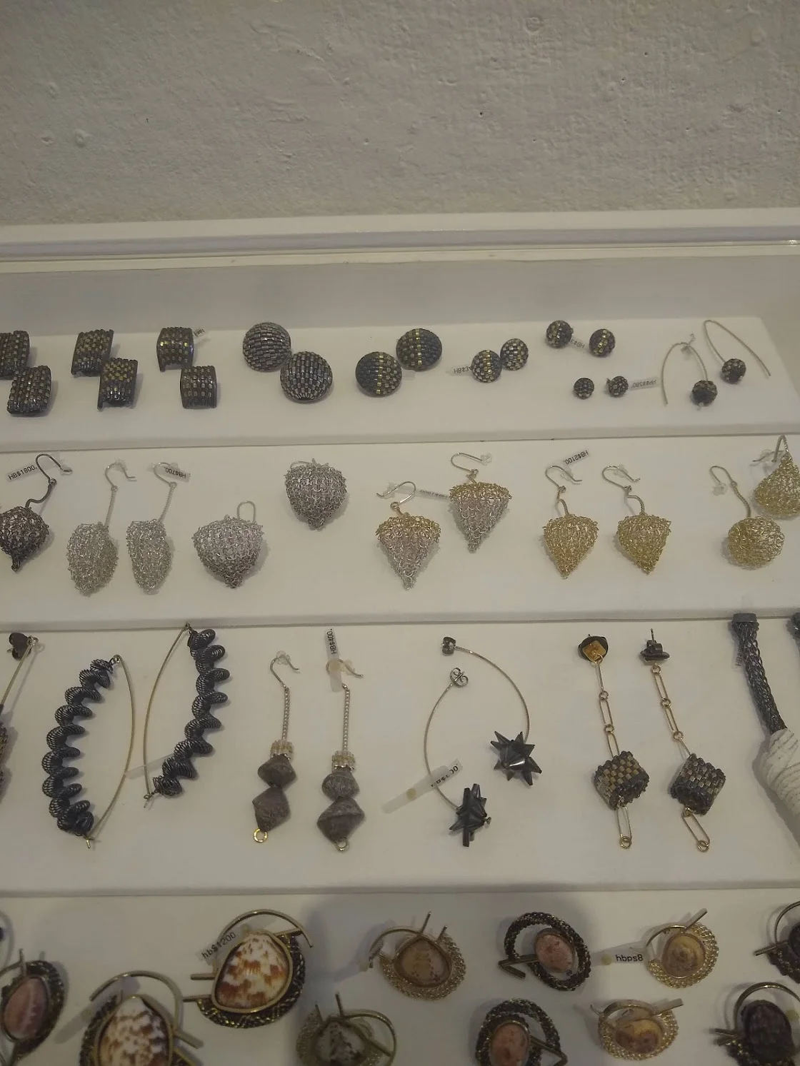 Hanne’s collection at Mobilia Gallery of both woven and knit designs in earrings and pins.