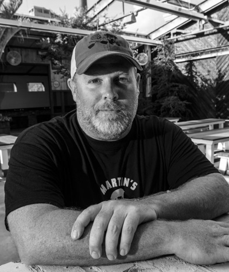 Pat Martin - Pitmaster & Founder - Martin's Bar-B-QuePat Martin learned the art and craft of West Tennessee-style smoke and meat 25 years ago in the tiny town of Henderson, TN before making Nashville his home. It became a consuming passion that eventually led to a business when he opened the first Martin's Bar-B-Que Joint in October of 2006 in Nolensville, Tennessee - just south of Nashville. Today, there are four locations in the Nashville area, including the newest serving those seeking great BBQ in Downtown Nashville.