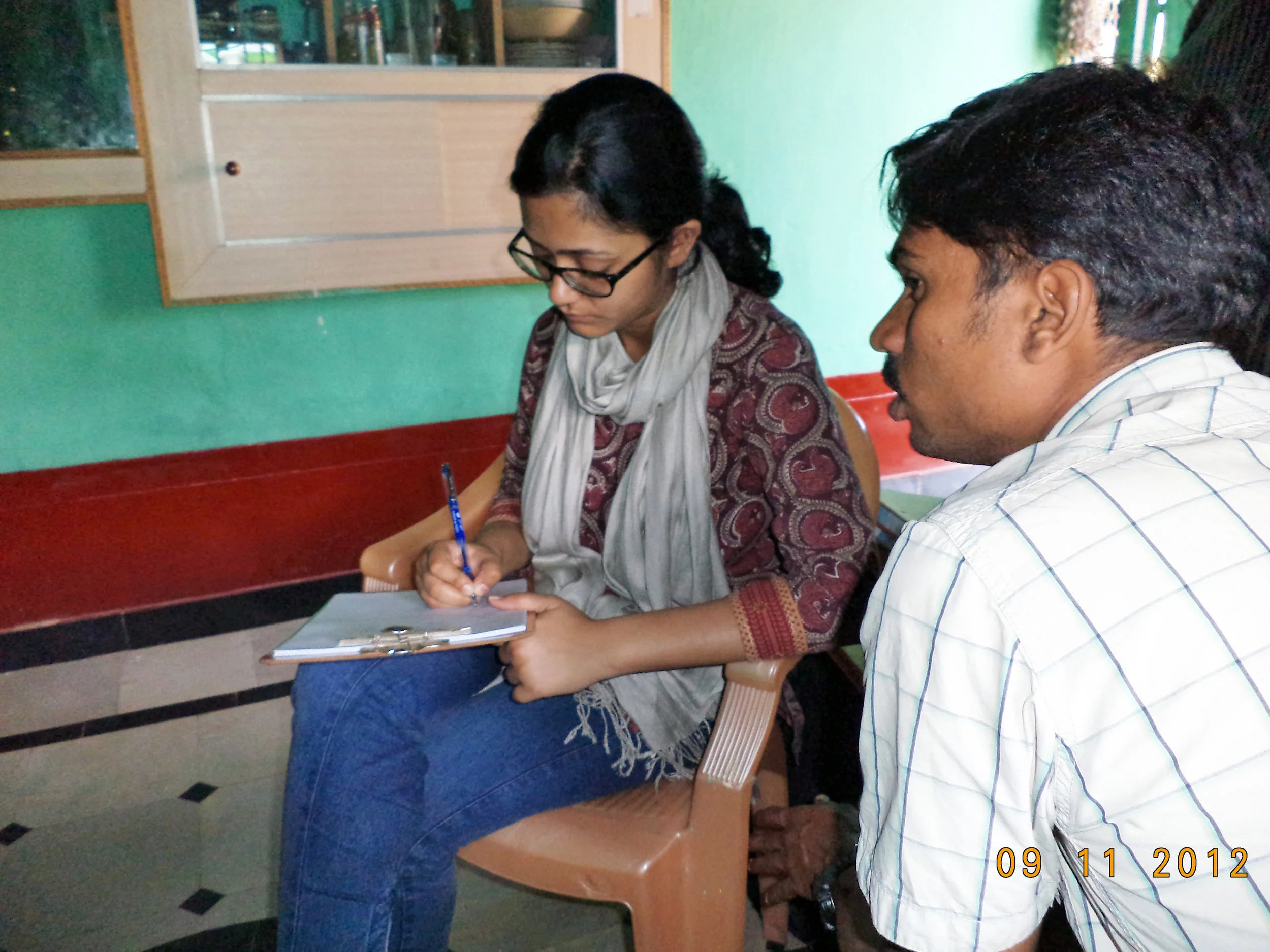 I interview villagers with the help of a translator in southern India
