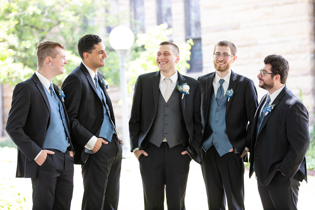 Groom and groomsmen laughing. 