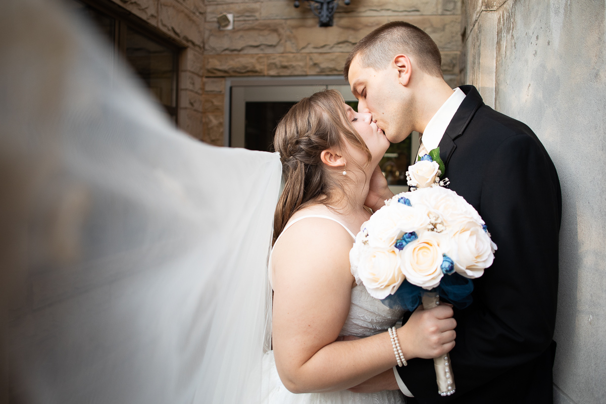 Bride and groom veil shot during formal photos. 