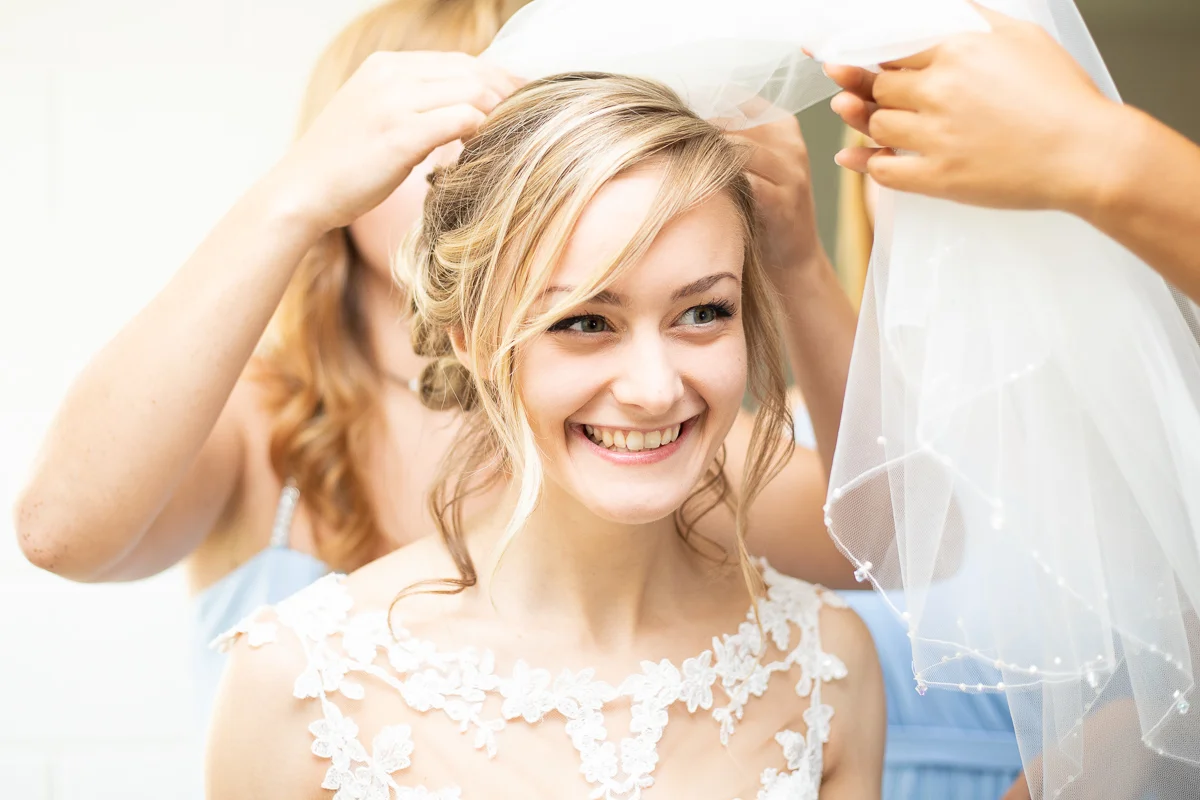 Bride getting ready and putting veil on. 