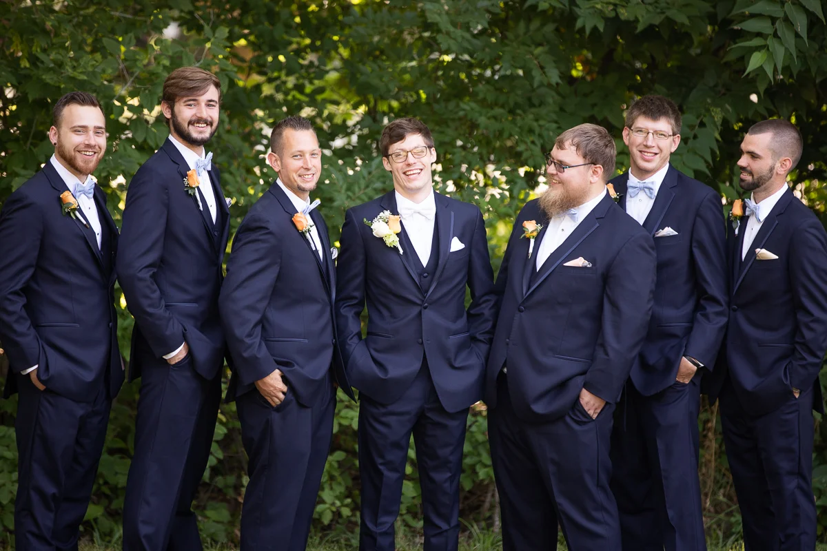 Groom and groomsmen laughing. 