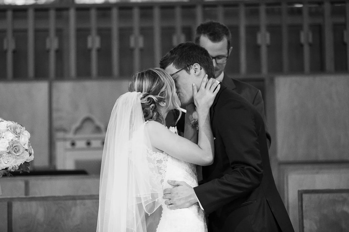 Bride and groom first kiss at wedding ceremony. 
