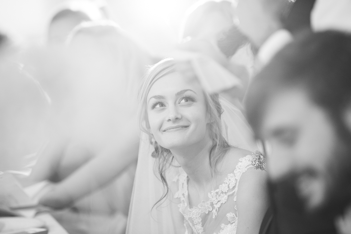 Bride during toasts at wedding reception. 
