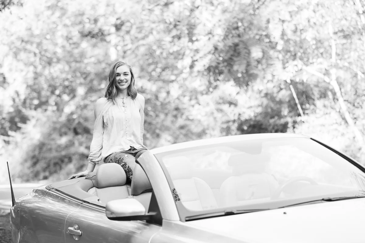 Black and white senior pictures with convertible at Hartwood Acres Mansion