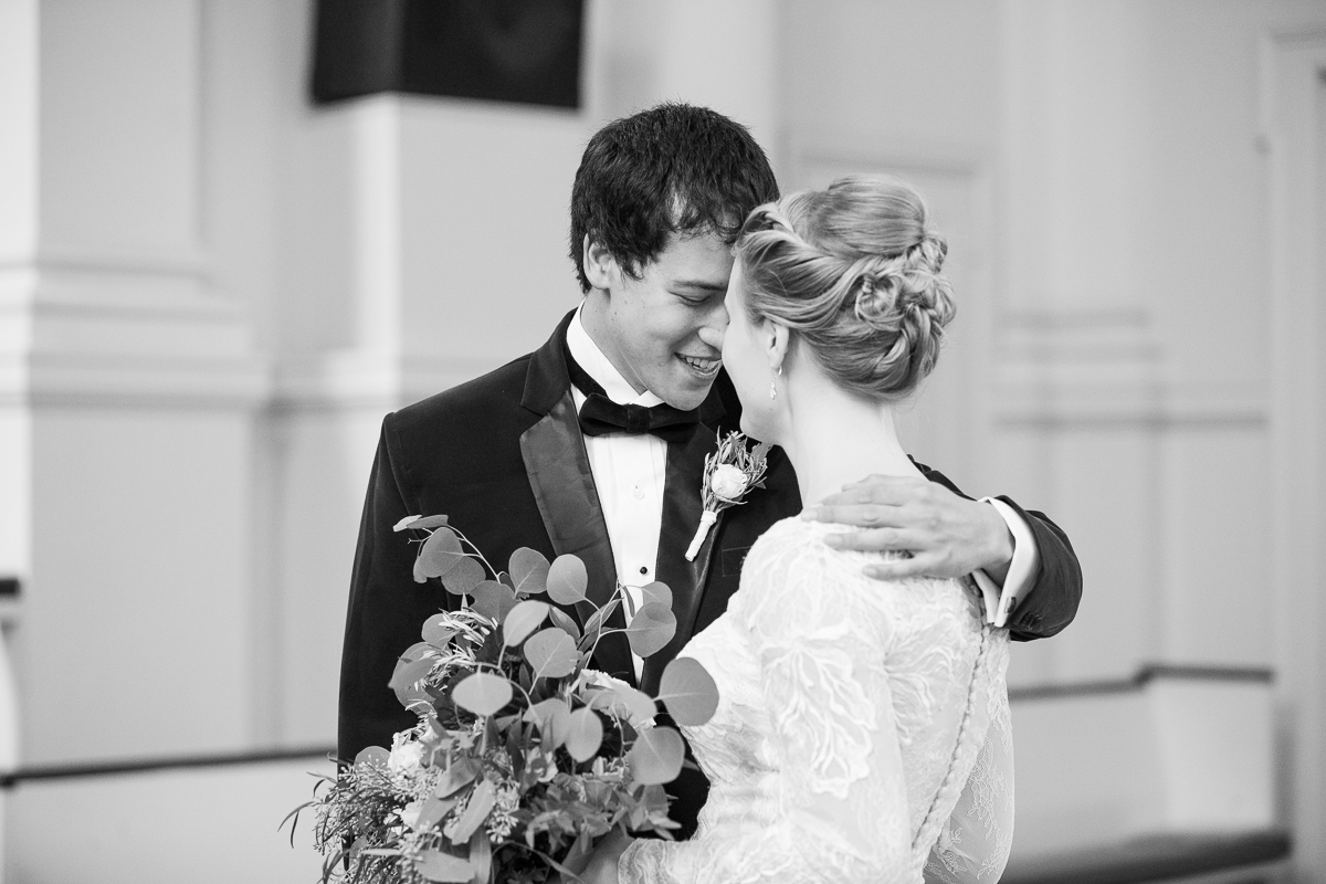 Black and white photo of bride and groom’s first look.