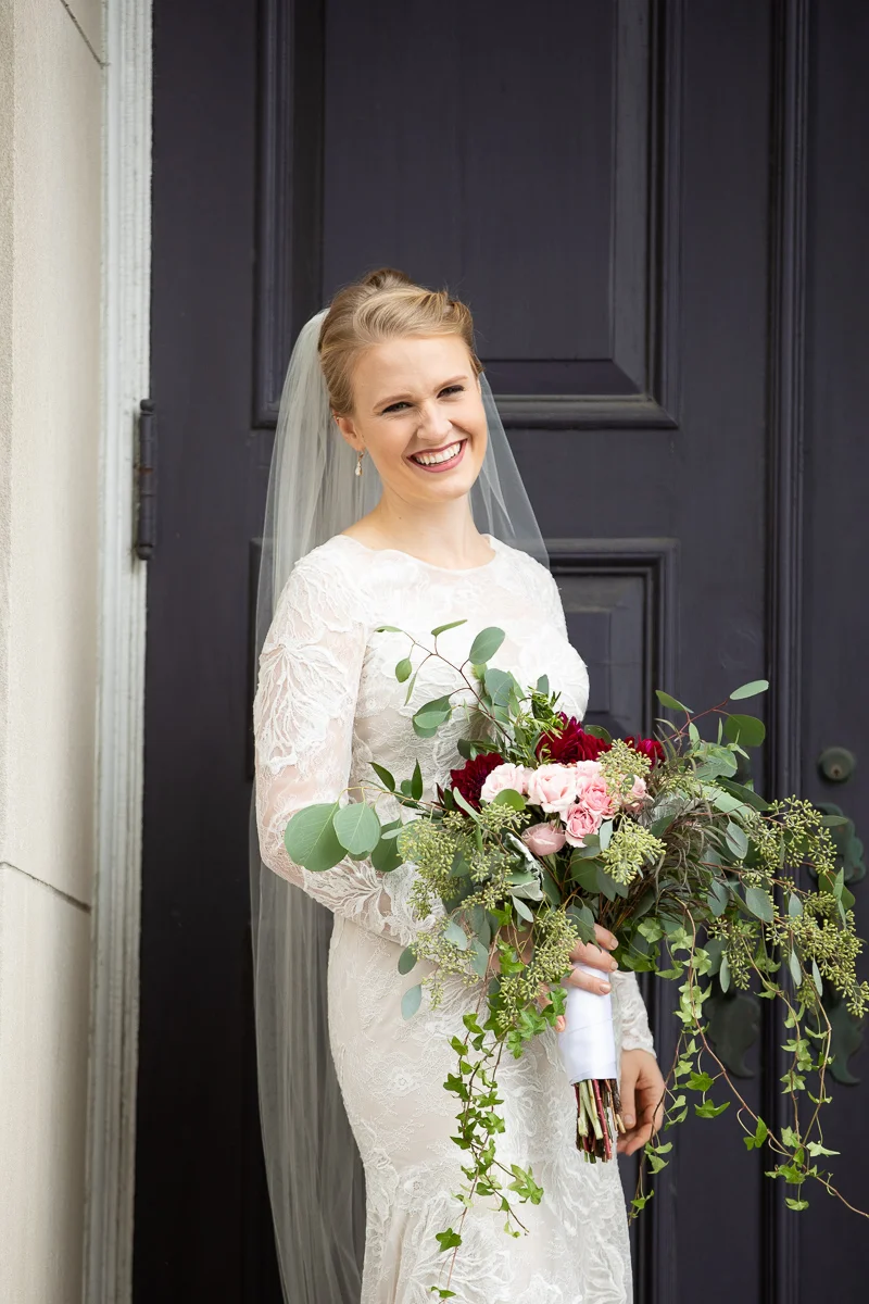 Bride laughing with bouquet at Boston wedding.