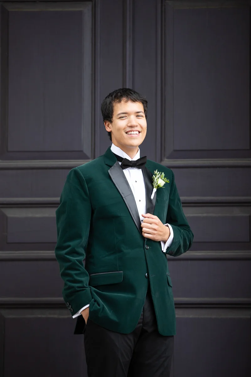 Groom laughing during formals at Boston wedding.