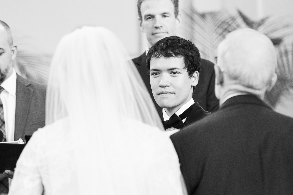 Groom looking at bride walk down the aisle.