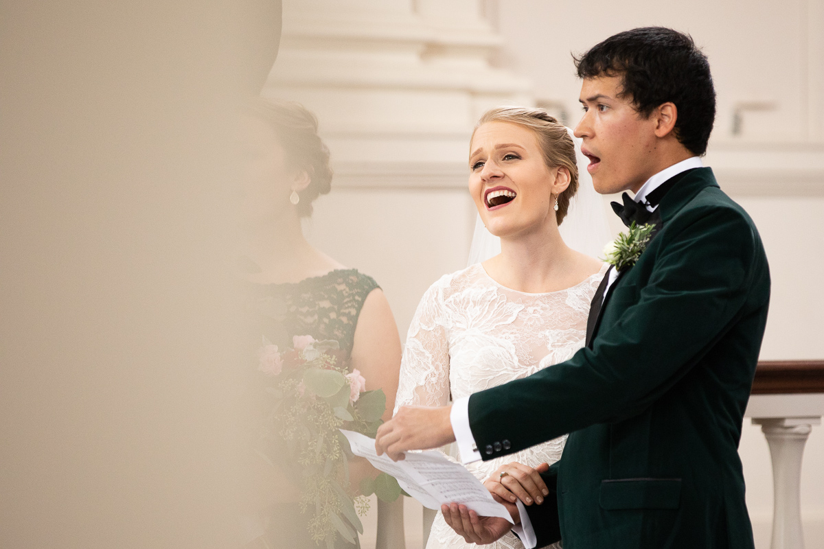 Bride and groom singing during wedding ceremony.