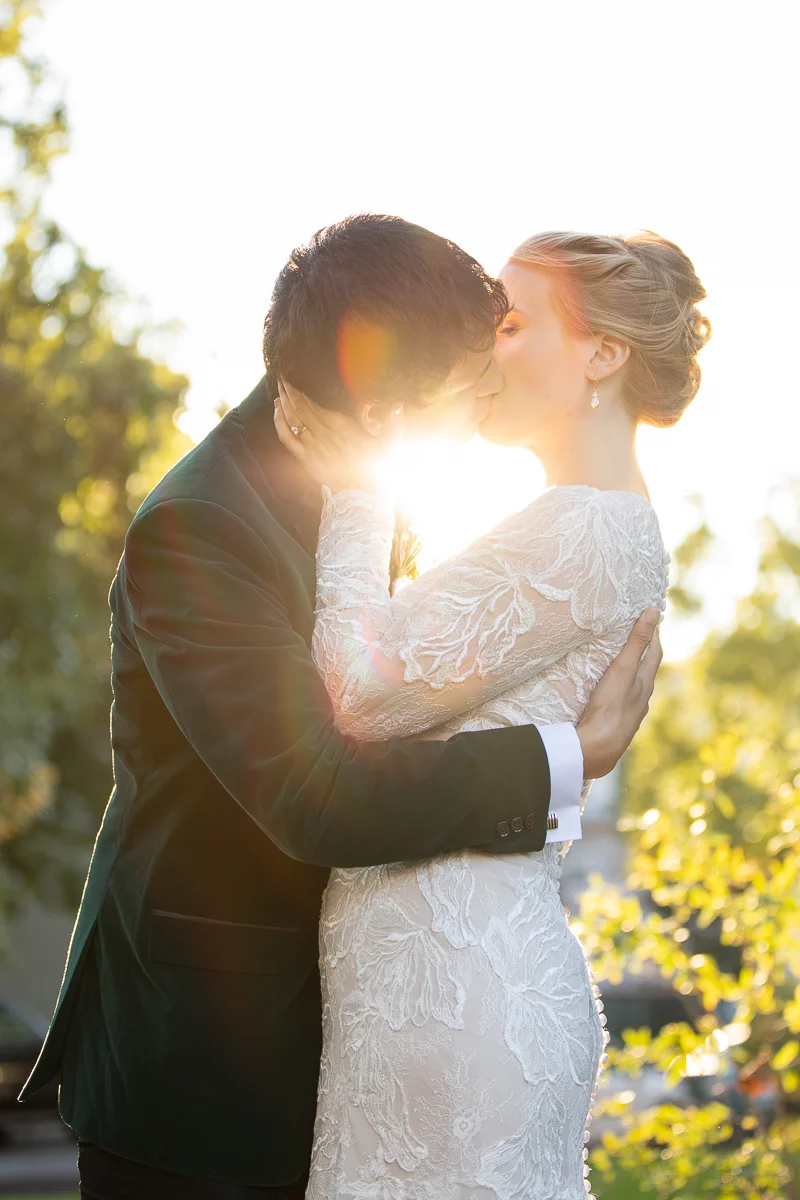 Bride and groom kissing at golden hour in Boston wedding.