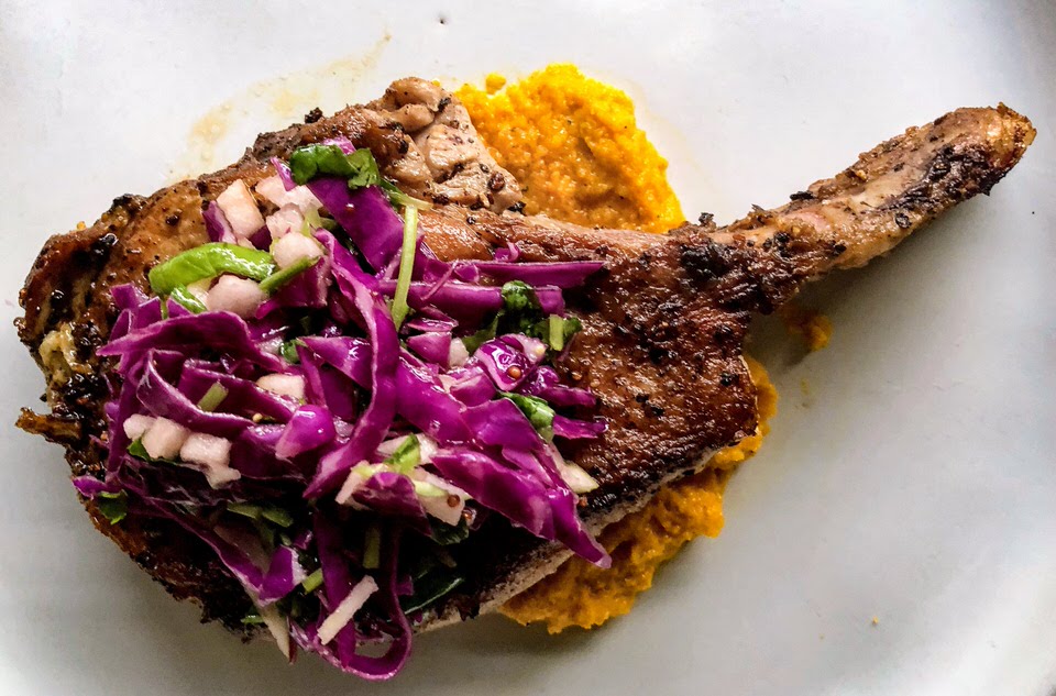 Plated spring bone-in Pork loin chop with carrot puree and apple slaw for spring.jpg