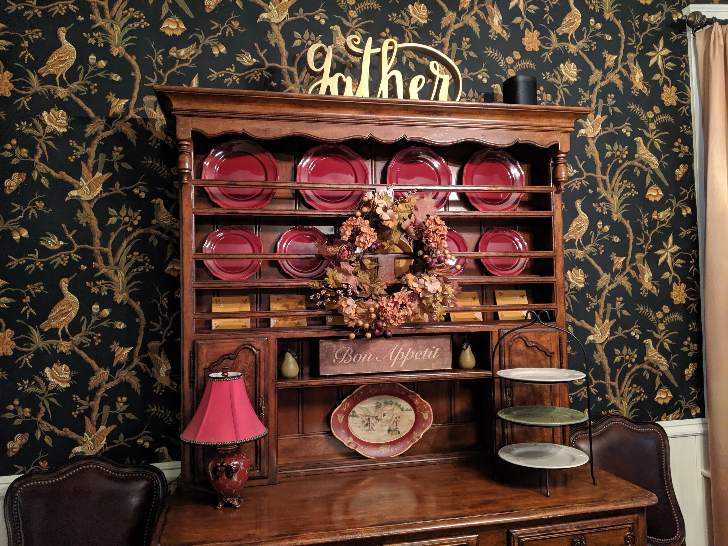 Wreaths aren’t just for front doors! Lori shows that a wreath layered over an existing piece can help pull a room together.