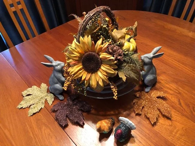 Mary Ellen’s fall sunflowers are accented by sparkling leaves and a wicker basket.
