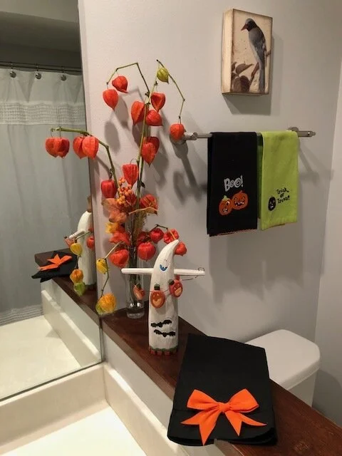 A few stems of orange lantern plant add playful color to Mary Ellen’s whimsical Halloween decorations.