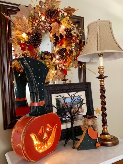 Whimsical Halloween decorations mix well with an autumnal wreath, as Joan shows here.