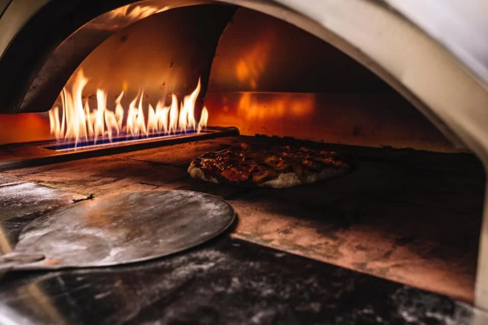 Wood-fired pizza baking at Casa Marana