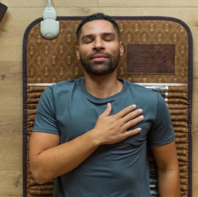 Man relaxes on biomat in carroll county maryland while deeply meditating