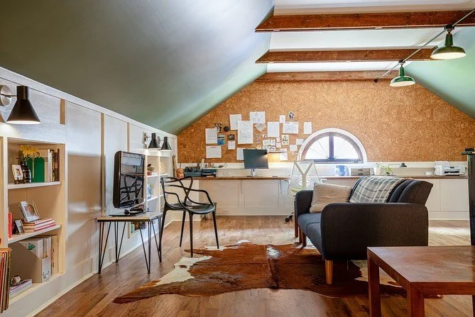 An unfinished attic in an old house became a beautiful new office and study, embracing the history and quirks of the space. Air ducts were hidden by two built-in desks, and the original beams raised to adorn the new ceiling.