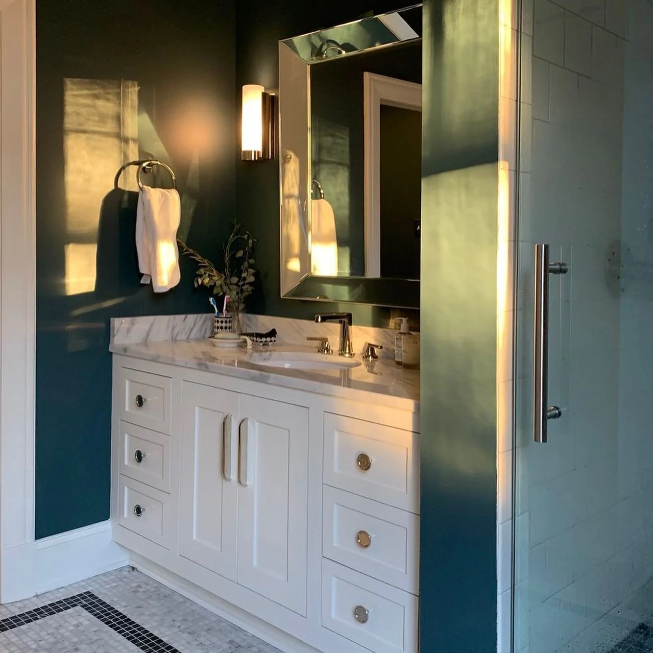 This hundred-year-old house never had a true owner&rsquo;s suite, with only a shared hall bathroom and very little closet space. By surgically cutting through to an adjoining bedroom, the space became a closet and bathroom, divided in two by floor-to