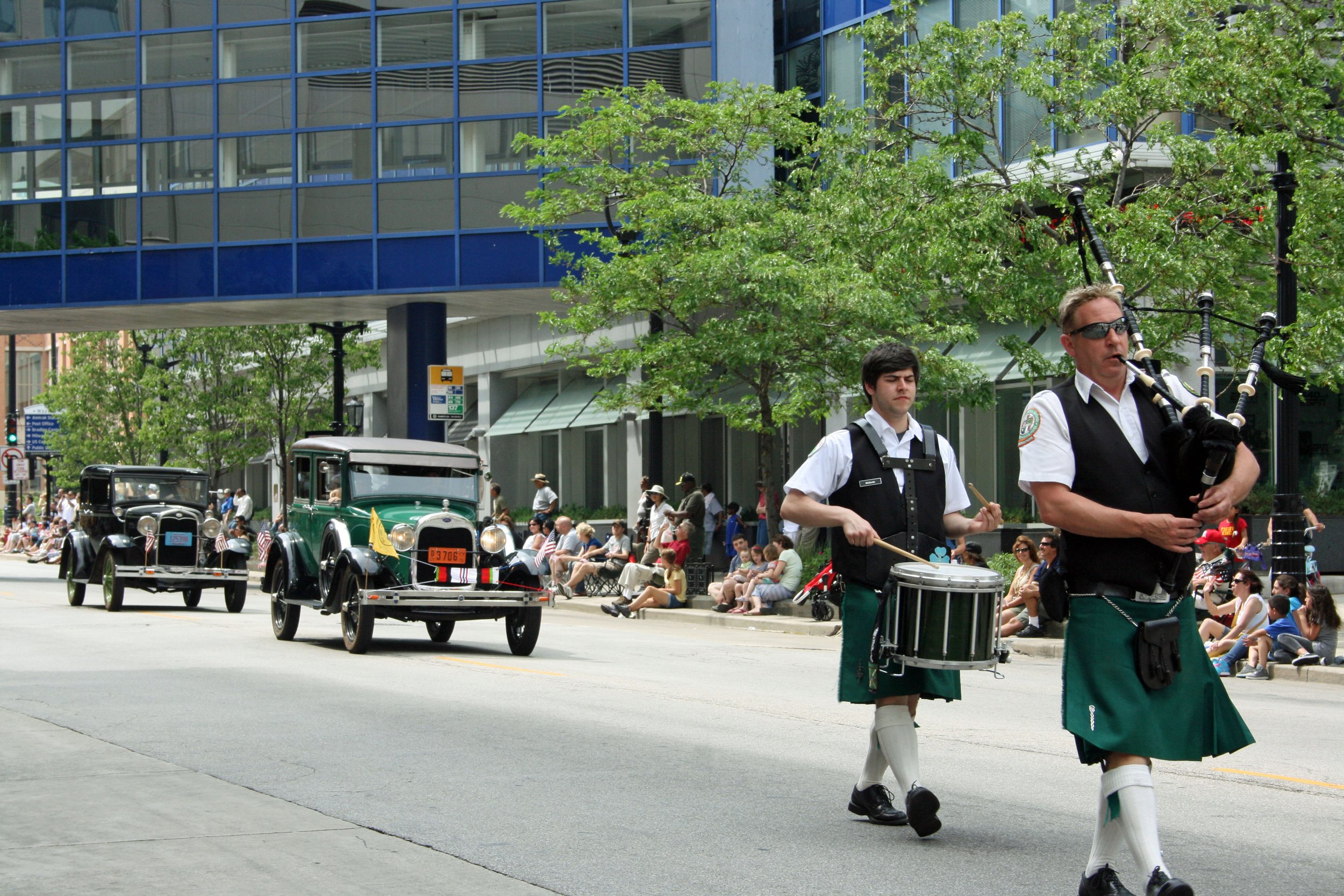 Neil & Bob's cars behind the Bagpipers.jpg