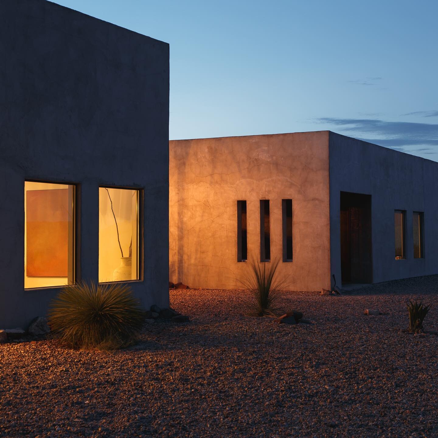This photo by @parker.thornton so accurately portrays Willow House. An austere, monochromatic exterior and a warm, glowing interior. Filled with friendly faces and familiar strangers that may become friends. A safe place to isolate in the vast desert