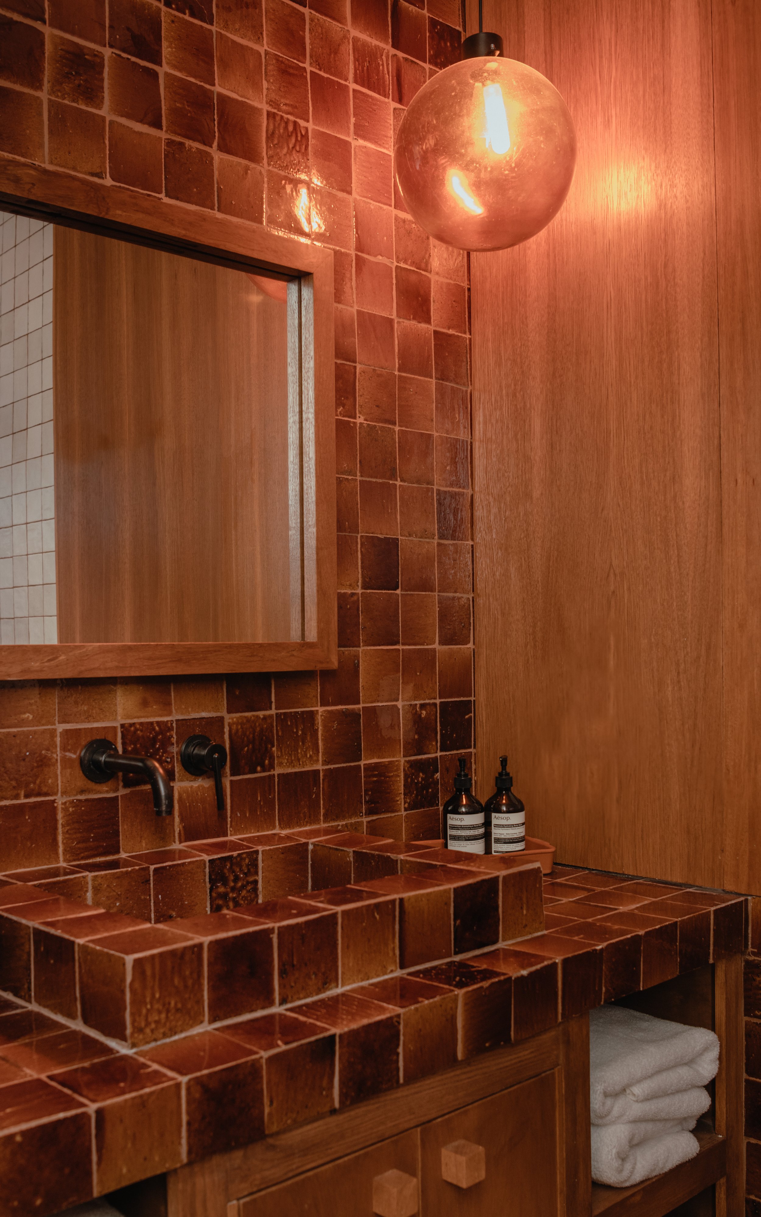 the warm bathroom light is a perfect match for this tile 