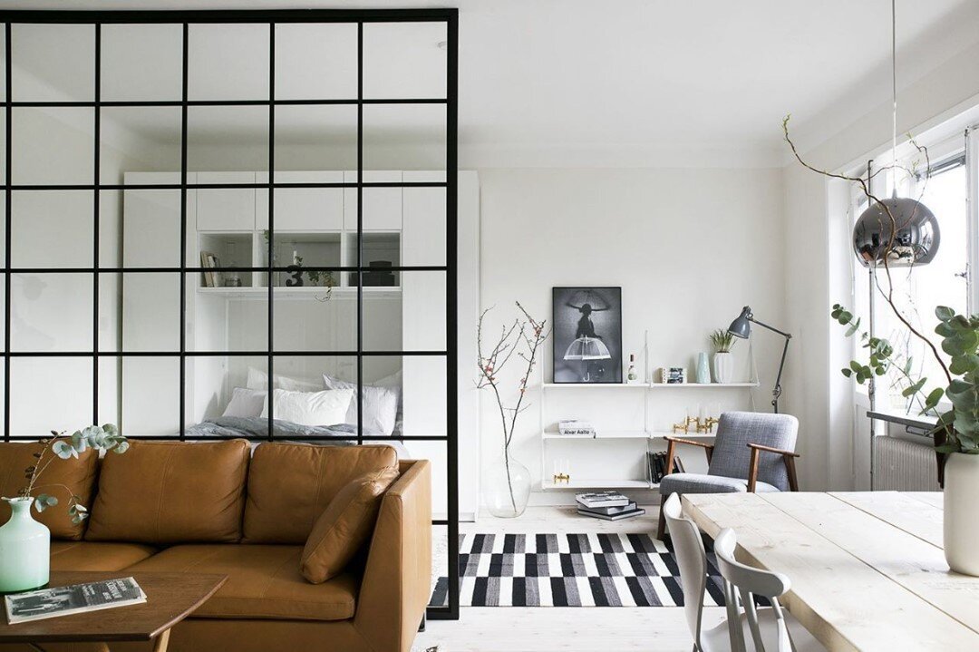 Defining spaces. Open concept floor plans are great way to maximize every square foot of small living spaces. I am a big fan of separating areas with airy room dividers like this glass framed wall. It adds visual interest, defines the purpose of each