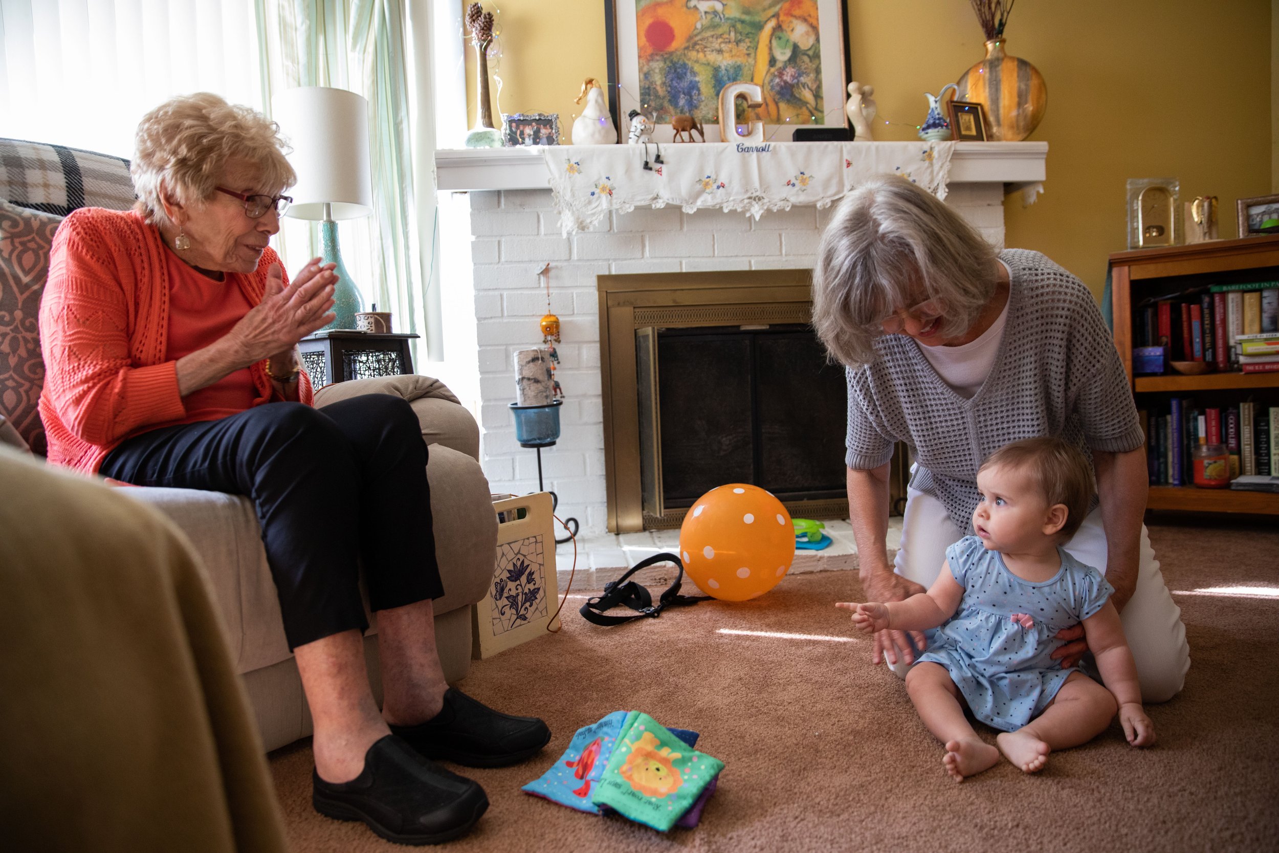   Alma Freeman (bottom right), six months old, interacts with her great-grandmother Caroline Ranucci (right) and great-aunt Janet Ranucci at a family get-together in Marlton, N.J. on Sept. 5, 2021.  